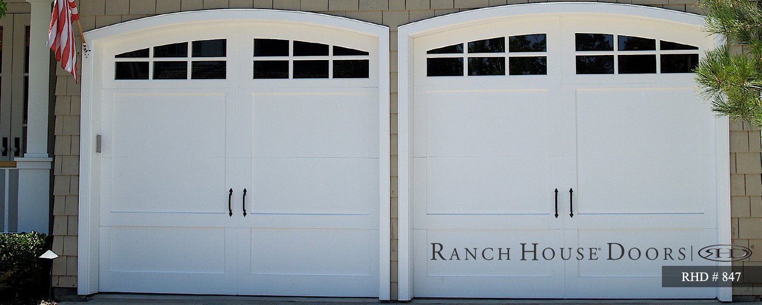 This is an image of a white wood Cape Cod style garage door in Laguna Beach, CA.
