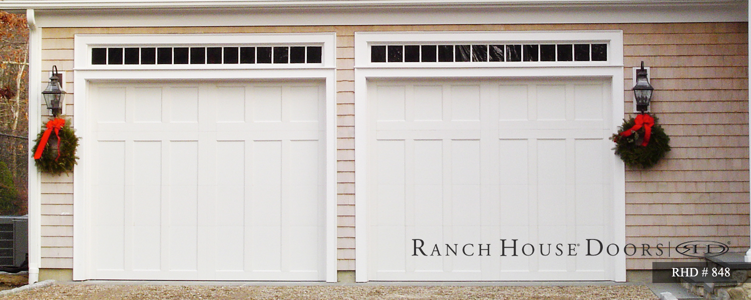 This is an image of a Cape Cod style white garage door with no windows.