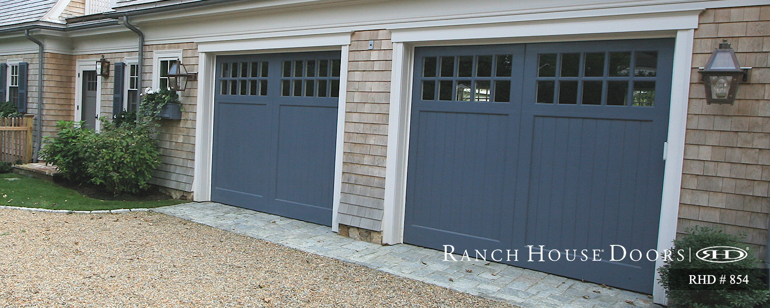 This is an image of a blue Cape Cod style garage door.