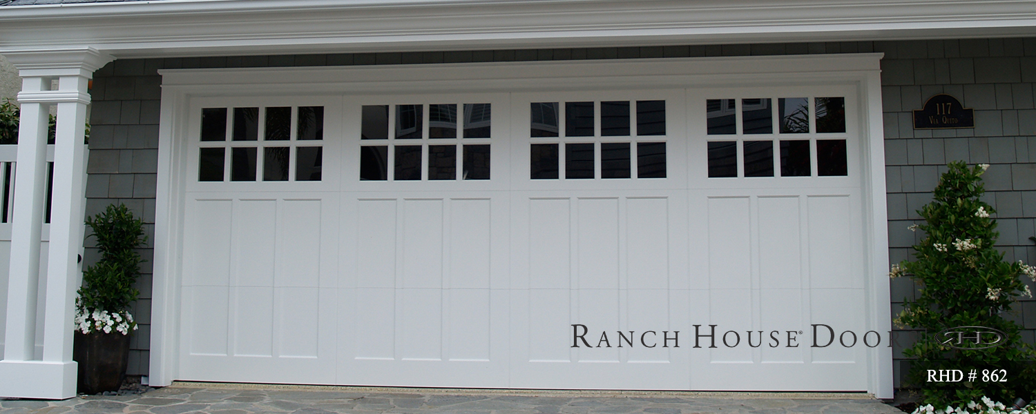 This is an image of a white wood Cape Cod style garage door in OC.