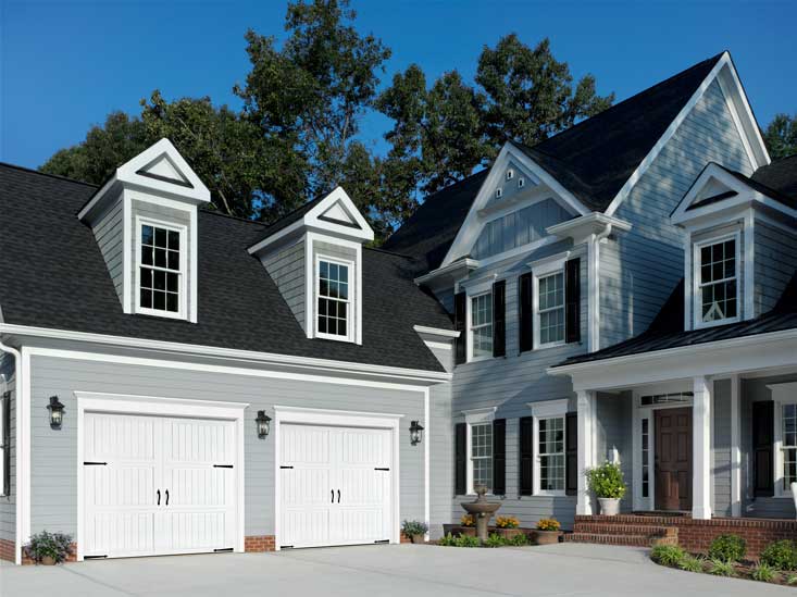 This is an image of a white carriage style steel garage door.