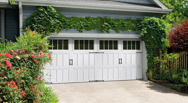 This is an image of a white Amarr Classica carriage house garage door with windows.