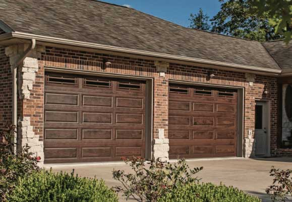 This is an image of a steel garage door with a faux wood color.