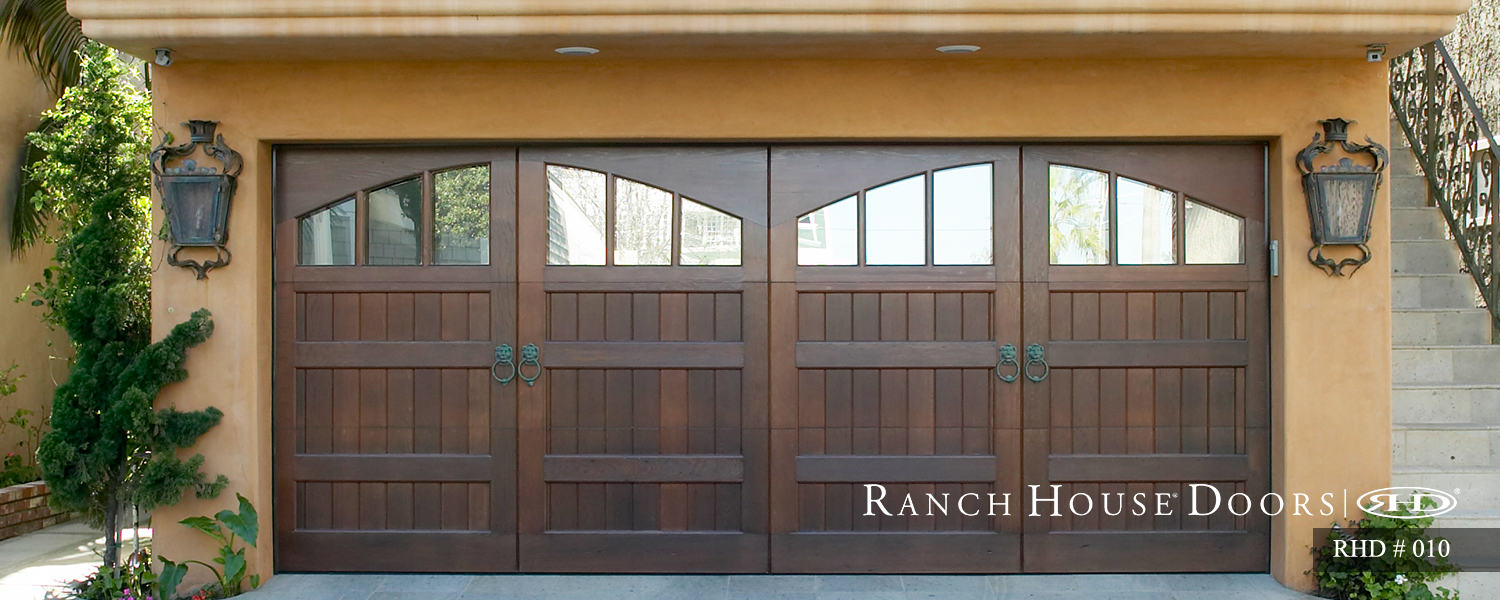 This is an image of a spanish style wood garage door with arched windows in Rancho Santa Margarita, CA.
