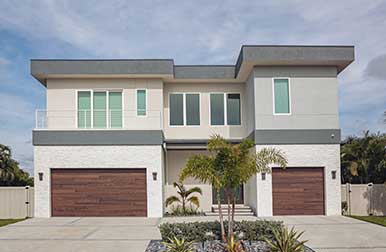 This is an image of a modern steel garage door with no windows in Tustin, CA.