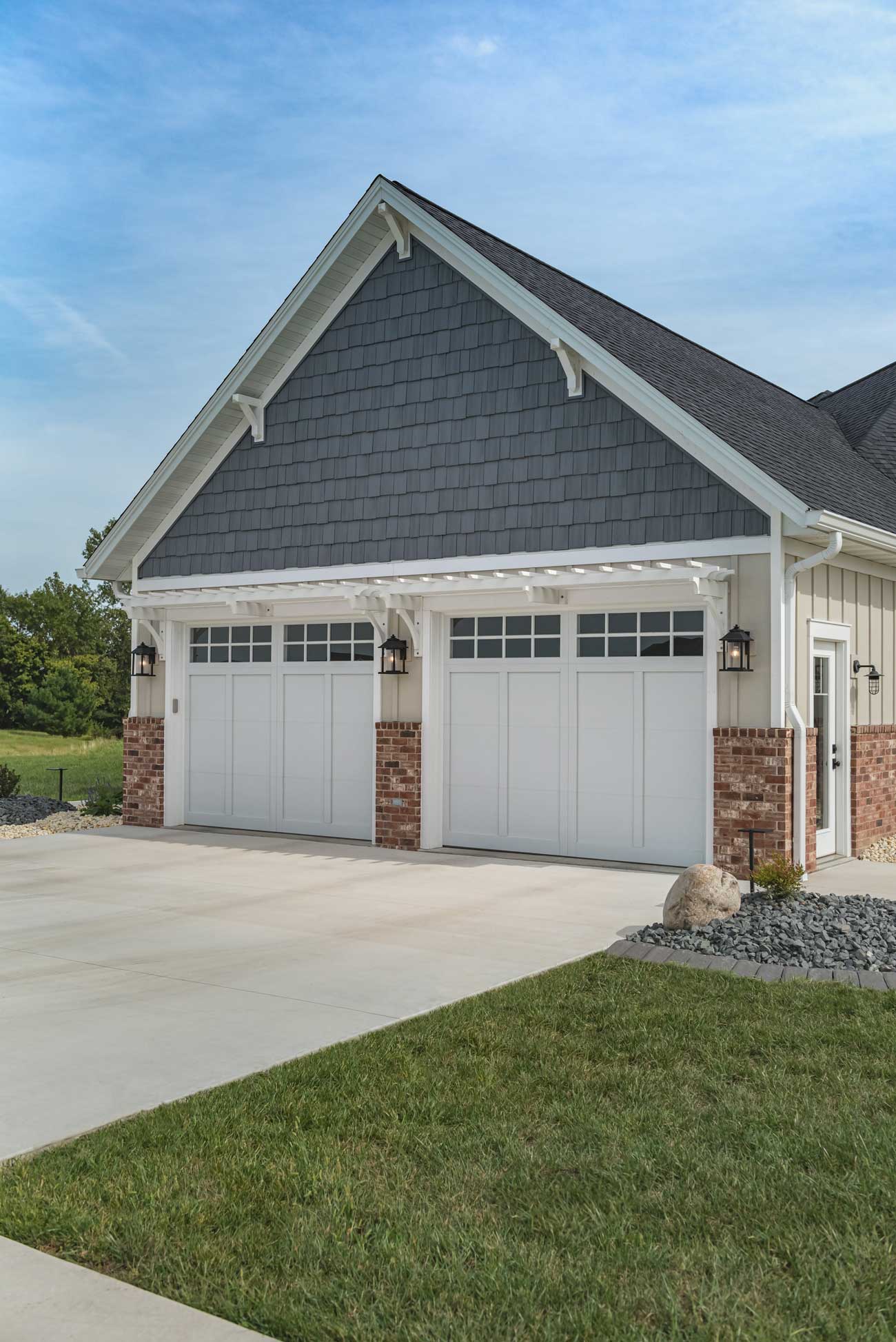 This is an image of a Wood garage door overlayed on a steel garage door with a carriage house style look.