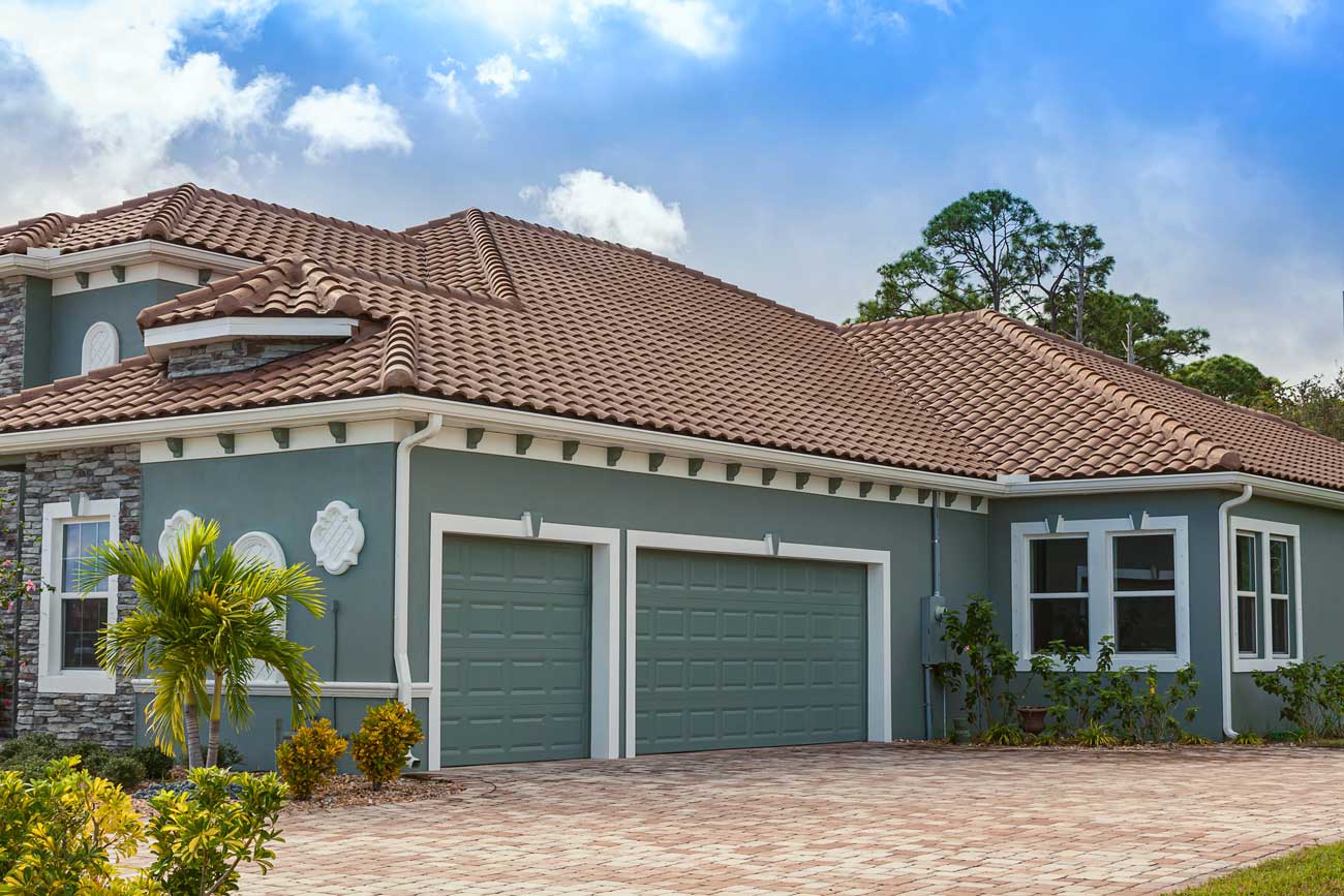 This is an image of a blue raised short panel garage door with no windows on an Orange County home.