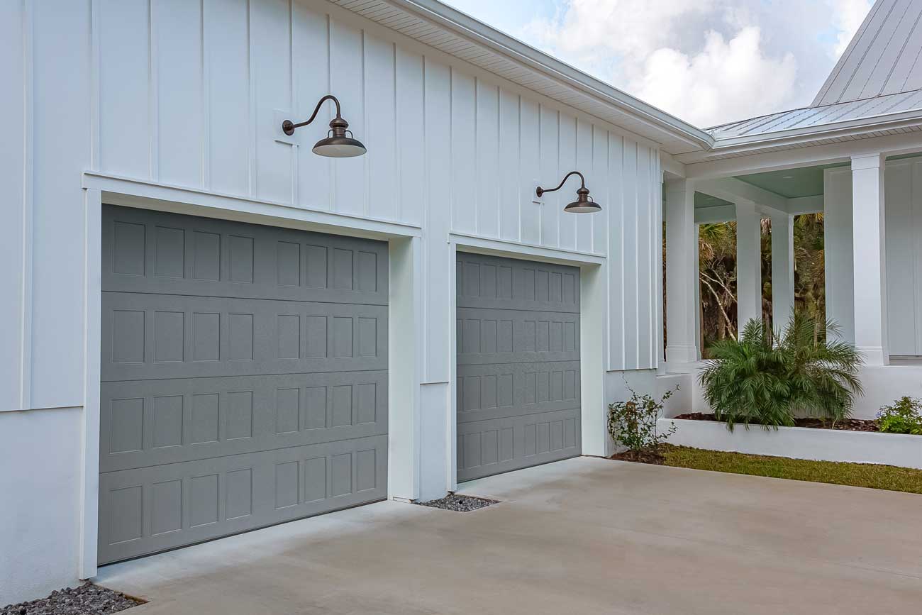 This is an image of a traditional grey garage door with no windows.
