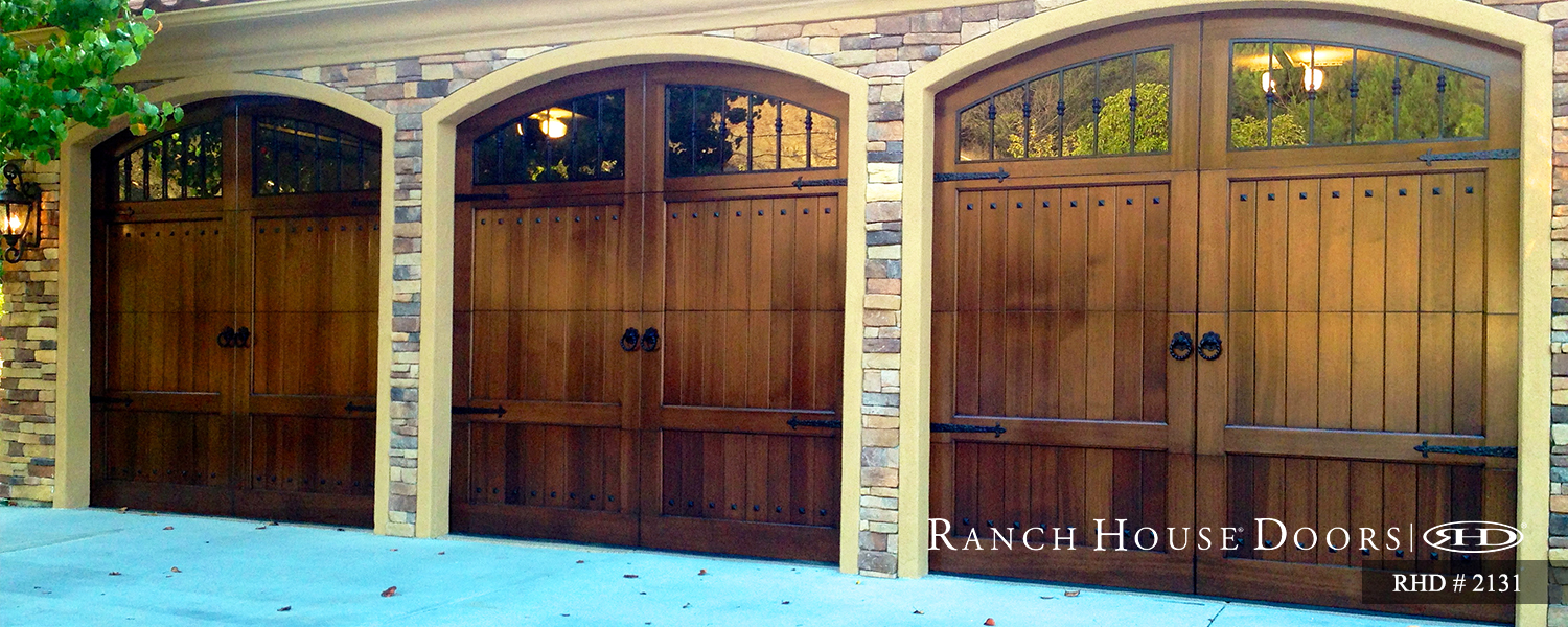 This is an image of a spanish style wood garage door with windows in Lake Forest, CA.