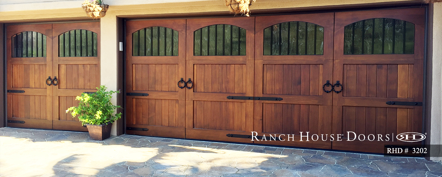 This is an image of a spanish style wood garage door with windows in Laguna Beach, CA.