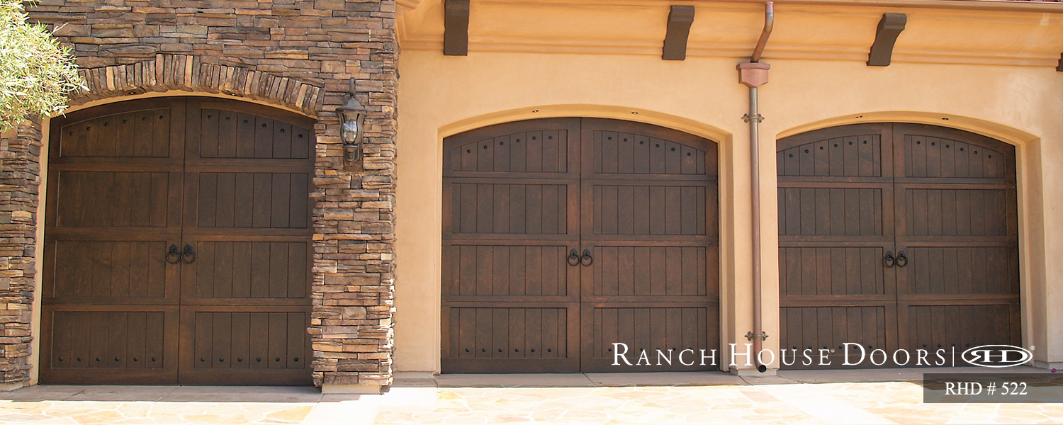 This is an image of a spanish style wood garage door with dark oak in Newport Beach, CA.