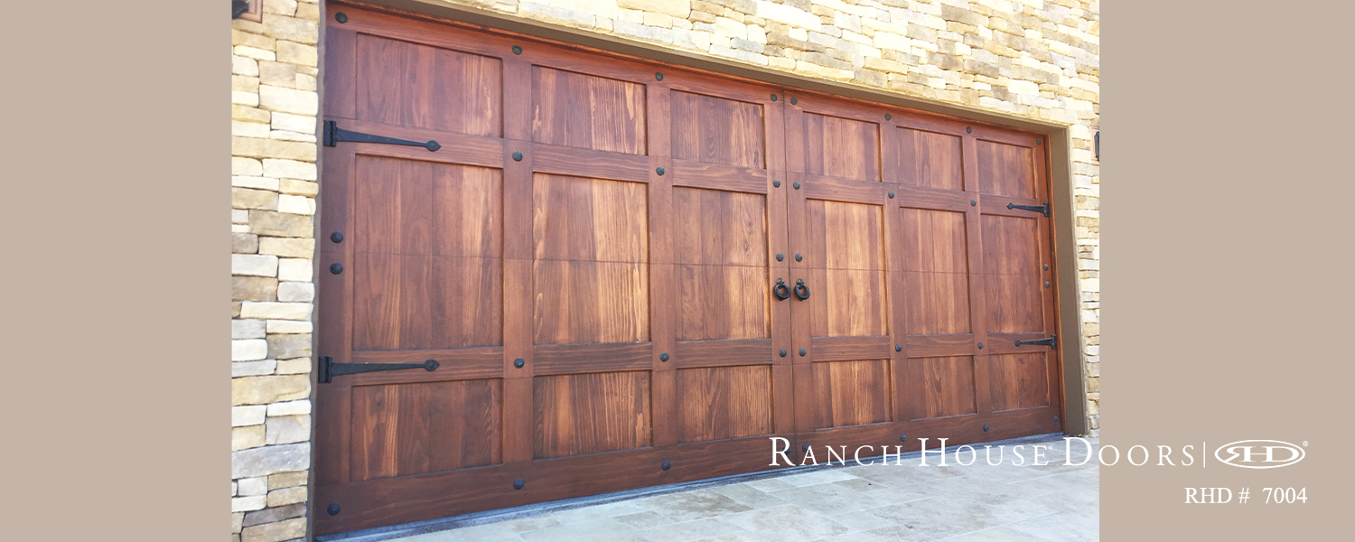 This is an image of a spanish style wood garage door with hardware in Dana Point, CA.