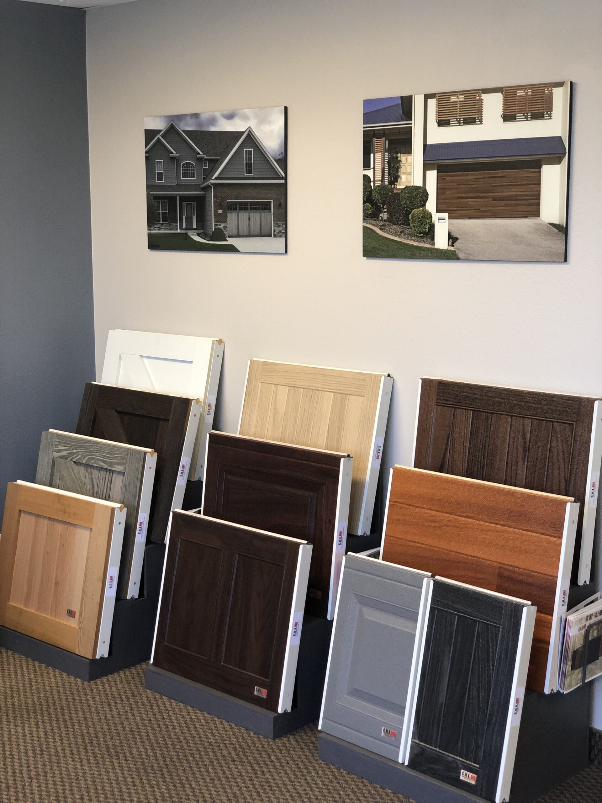 This is an image of some garage door panel samples of various styles and colors at the Entry Systems design center in Laguna Hills, California.
