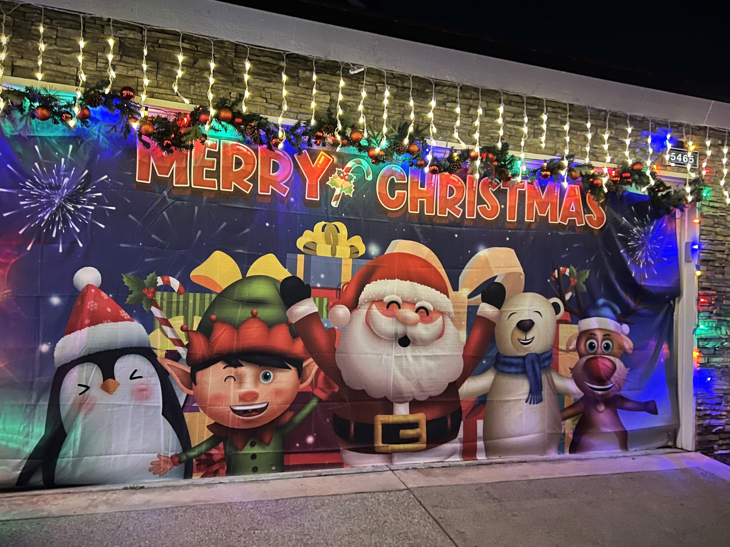 Garage door decorations featuring santa and friends.